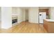 Open-concept living room with fireplace, hardwood floors, and kitchen island at 300 Maple Grove Ct, Canton, GA 30114