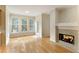 Cozy living space with hardwood floors, a fireplace, and access to the backyard at 300 Maple Grove Ct, Canton, GA 30114