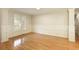 Light-filled living room with hardwood floors, white wainscoting, and large windows at 300 Maple Grove Ct, Canton, GA 30114