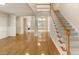 Bright, open-concept living space with hardwood floors and staircase at 300 Maple Grove Ct, Canton, GA 30114