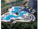 Stunning aerial view of a community pool area with water slides, lounge chairs, cabanas and manicured landscaping at 300 Maple Grove Ct, Canton, GA 30114