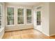 Bright sunroom with hardwood floors, large windows, and access to the deck at 300 Maple Grove Ct, Canton, GA 30114
