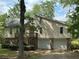 Charming two-story home featuring a front-facing two car garage and a wooden porch with stairs at 6070 Ridge Way, Douglasville, GA 30135