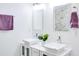 Bright bathroom featuring double sinks with modern faucets, neutral paint, and square mirrors at 1166 Mcdaniel Sw St, Atlanta, GA 30310
