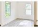 This bedroom has neutral paint, two windows offering plenty of light, and wood-look floors at 1166 Mcdaniel Sw St, Atlanta, GA 30310