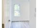 Bedroom with light wood-look floors, white walls, white trim, and a bright window view at 1166 Mcdaniel Sw St, Atlanta, GA 30310