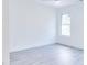 Bright bedroom with wood-look floors, white walls, white trim, and a bright window view at 1166 Mcdaniel Sw St, Atlanta, GA 30310