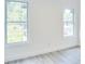 Bedroom with wood-look floors, white walls, white trim, and two bright windows at 1166 Mcdaniel Sw St, Atlanta, GA 30310