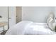 Bright bedroom with white bedding, neutral walls, and a modern side table at 1166 Mcdaniel Sw St, Atlanta, GA 30310