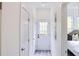 Hallway with bed and pillows visible, with access to the back yard. Interior is bright and clean at 1166 Mcdaniel Sw St, Atlanta, GA 30310