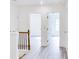 Bright hallway with wood-look floors, white walls and trim, and classic iron railing at 1166 Mcdaniel Sw St, Atlanta, GA 30310