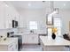 Modern kitchen featuring white cabinets, stainless appliances, and quartz countertops at 1166 Mcdaniel Sw St, Atlanta, GA 30310