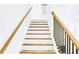 Staircase featuring wooden treads and white risers, complemented by a wood and iron railing at 1166 Mcdaniel Sw St, Atlanta, GA 30310