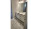 Bathroom with marble floors, white cabinets, double sinks, and a large mirror at 3032 Farm Tract Trl, Woodstock, GA 30189