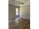 Serene bedroom featuring a tray ceiling, neutral walls, and hardwood floors at 3032 Farm Tract Trl, Woodstock, GA 30189