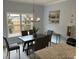 Well-lit dining area with a modern light fixture, neutral colors, and natural light at 3032 Farm Tract Trl, Woodstock, GA 30189