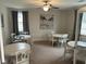 Cozy dining area with white tables, chairs, and ample natural lighting at 3032 Farm Tract Trl, Woodstock, GA 30189