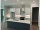 Well-lit kitchen featuring a sizable island, modern appliances, and sleek design at 3032 Farm Tract Trl, Woodstock, GA 30189