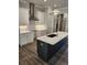 This kitchen features a large island, white cabinets, stainless steel appliances, and pendant lighting at 3032 Farm Tract Trl, Woodstock, GA 30189