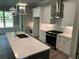 Modern kitchen boasts a spacious island, stainless steel appliances, and ample cabinet space at 3032 Farm Tract Trl, Woodstock, GA 30189
