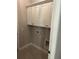 Functional laundry room includes storage cabinets and tile flooring at 3032 Farm Tract Trl, Woodstock, GA 30189
