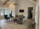 Cozy community living room with vaulted ceilings, a fan, and wood-look flooring at 3032 Farm Tract Trl, Woodstock, GA 30189