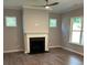Cozy living room with a fireplace, neutral walls, and hardwood floors at 3032 Farm Tract Trl, Woodstock, GA 30189