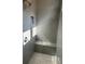 Modern shower features sleek tile work, a built-in seat, and a convenient niche at 3032 Farm Tract Trl, Woodstock, GA 30189