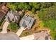 An aerial view showcasing a home with lush landscaping, a patio, and nearby mature trees at 3167 Blairhill Ct, Atlanta, GA 30340