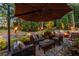 Inviting backyard patio with a fire pit, comfortable seating, ambient lighting, and lush greenery at 3167 Blairhill Ct, Atlanta, GA 30340