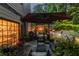 Cozy backyard patio with comfortable seating, ambient lighting, and lush greenery for relaxation and entertainment at 3167 Blairhill Ct, Atlanta, GA 30340