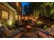 Inviting backyard patio with a fire pit, outdoor seating, and soft lighting for cozy evenings at 3167 Blairhill Ct, Atlanta, GA 30340