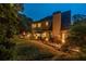Twilight view of a landscaped backyard, highlighted by soft lighting and lush greenery at 3167 Blairhill Ct, Atlanta, GA 30340