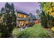 An enchanting backyard featuring soft outdoor lighting, comfortable seating, and mature trees for added privacy at 3167 Blairhill Ct, Atlanta, GA 30340