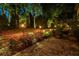 Beautiful backyard featuring a stone pathway, lush plants, and soft outdoor lighting for ambiance at 3167 Blairhill Ct, Atlanta, GA 30340