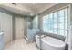 Stunning bathroom featuring a glass shower, a soaking tub, and tile flooring at 3167 Blairhill Ct, Atlanta, GA 30340