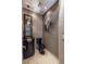 Elegant powder room with black fixtures, textured wallpaper, decorative mirror, and tiled flooring at 3167 Blairhill Ct, Atlanta, GA 30340