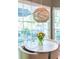 Close-up of a dining table with tulips, a modern light fixture, and window views at 3167 Blairhill Ct, Atlanta, GA 30340