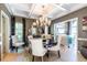 Dining room with chandelier, table, and chairs, connecting to a cozy living space at 3167 Blairhill Ct, Atlanta, GA 30340