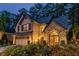 An elegant two-story house with a stone accent facade, a well-maintained yard, and ample outdoor lighting at 3167 Blairhill Ct, Atlanta, GA 30340