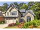 Charming two-story home with stone accents, gray shutters, a two-car garage, and mature landscaping at 3167 Blairhill Ct, Atlanta, GA 30340