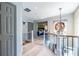 Upstairs hallway with art, fresh paint, hardwood floors, and open staircase at 3167 Blairhill Ct, Atlanta, GA 30340