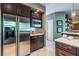 Kitchen with dark wood cabinets, stainless steel fridge, and built-in microwave at 3167 Blairhill Ct, Atlanta, GA 30340