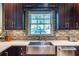Kitchen features a stainless steel sink, dark wood cabinetry, and a tiled backsplash at 3167 Blairhill Ct, Atlanta, GA 30340
