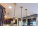 Modern kitchen featuring a trio of pendant lights, dark wood cabinets, and stainless steel appliances at 3167 Blairhill Ct, Atlanta, GA 30340