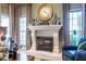 Inviting living room with a stone fireplace, large clock, and well-appointed decor at 3167 Blairhill Ct, Atlanta, GA 30340