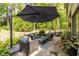 Inviting outdoor patio with comfortable seating, a cantilevered umbrella, and lush greenery at 3167 Blairhill Ct, Atlanta, GA 30340
