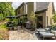 Charming outdoor patio with lounge chairs, an umbrella, lush greenery, and well-placed potted plants at 3167 Blairhill Ct, Atlanta, GA 30340