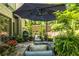 Inviting outdoor patio featuring comfortable seating, an umbrella, and lush greenery, perfect for relaxation at 3167 Blairhill Ct, Atlanta, GA 30340