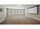 Large bonus room with a projector screen and neutral carpet at 3345 Palmer Lake Pointe, Douglasville, GA 30135